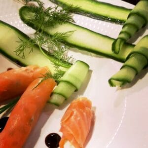 Black Mountain Roulade of Smoked Salmon - Welsh smoked salmon, spring onion & cream cheese, with scrolls of balsamic glazed cucumber, parsley & samphire gremolata