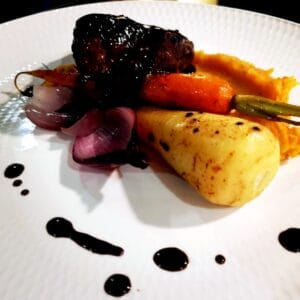Marinated Fillet of Hereford Beef -Smoked bone marrow, braised forest mushrooms, Roasted parsnip, & creamed root vegetables, Served with a rosemary & thyme red wine jus -