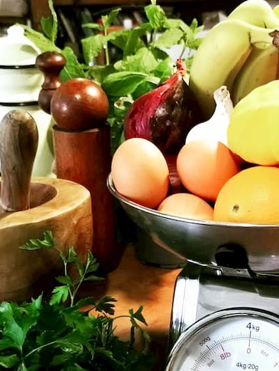 Fresh produce on scales in rustic kitchen